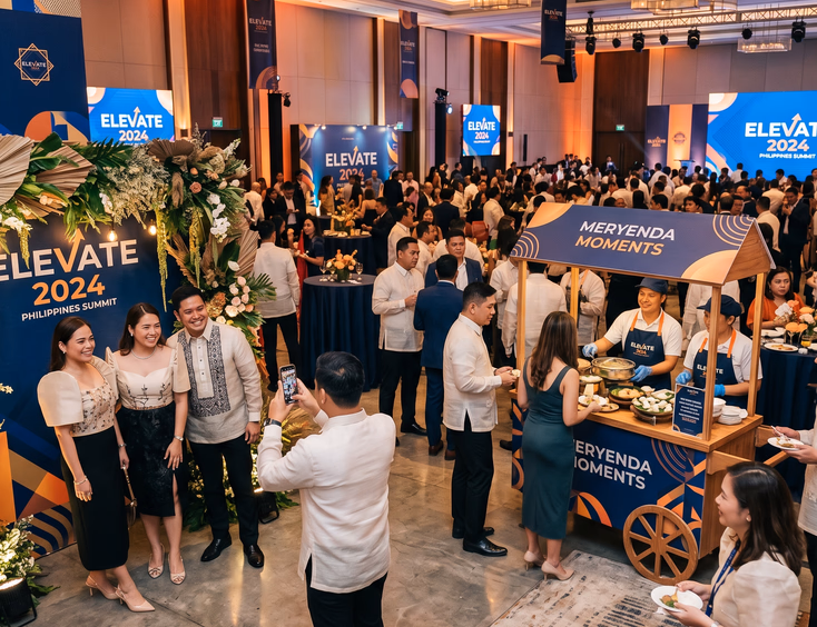 Modern Filipino corporate event featuring an interactive food cart, branded photo backdrop, and well-dressed guests mingling in a vibrant atmosphere.