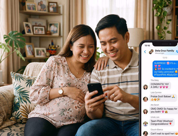 A happy Filipino couple at home types a gender reveal announcement in a family group chat on a phone, with reactions popping up in soft light.