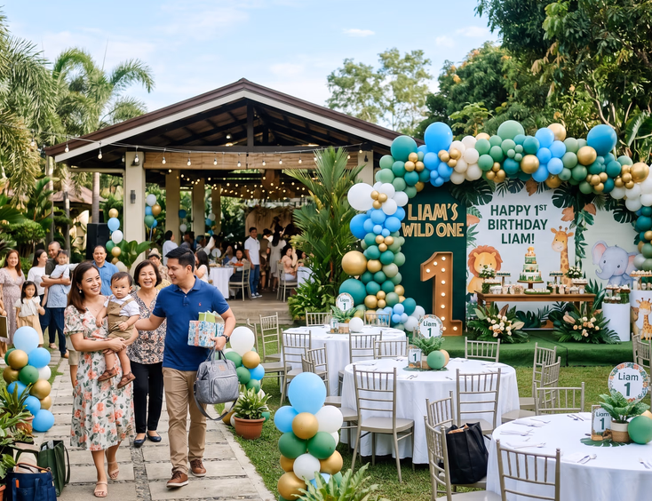 A decorated garden venue for a Filipino first birthday celebration, featuring themed centerpieces, a balloon backdrop, and arriving guests.