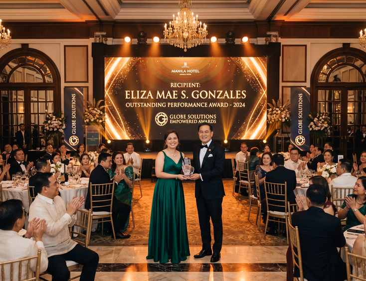 Filipino corporate awards night in a Manila hotel, with an employee accepting a trophy on stage before a large LED screen.