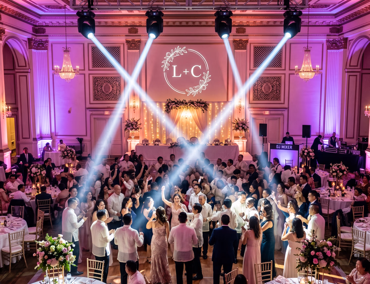 Filipino wedding reception ballroom with purple and blush pink uplighting, moving head beams, gobo monogram, and guests dancing