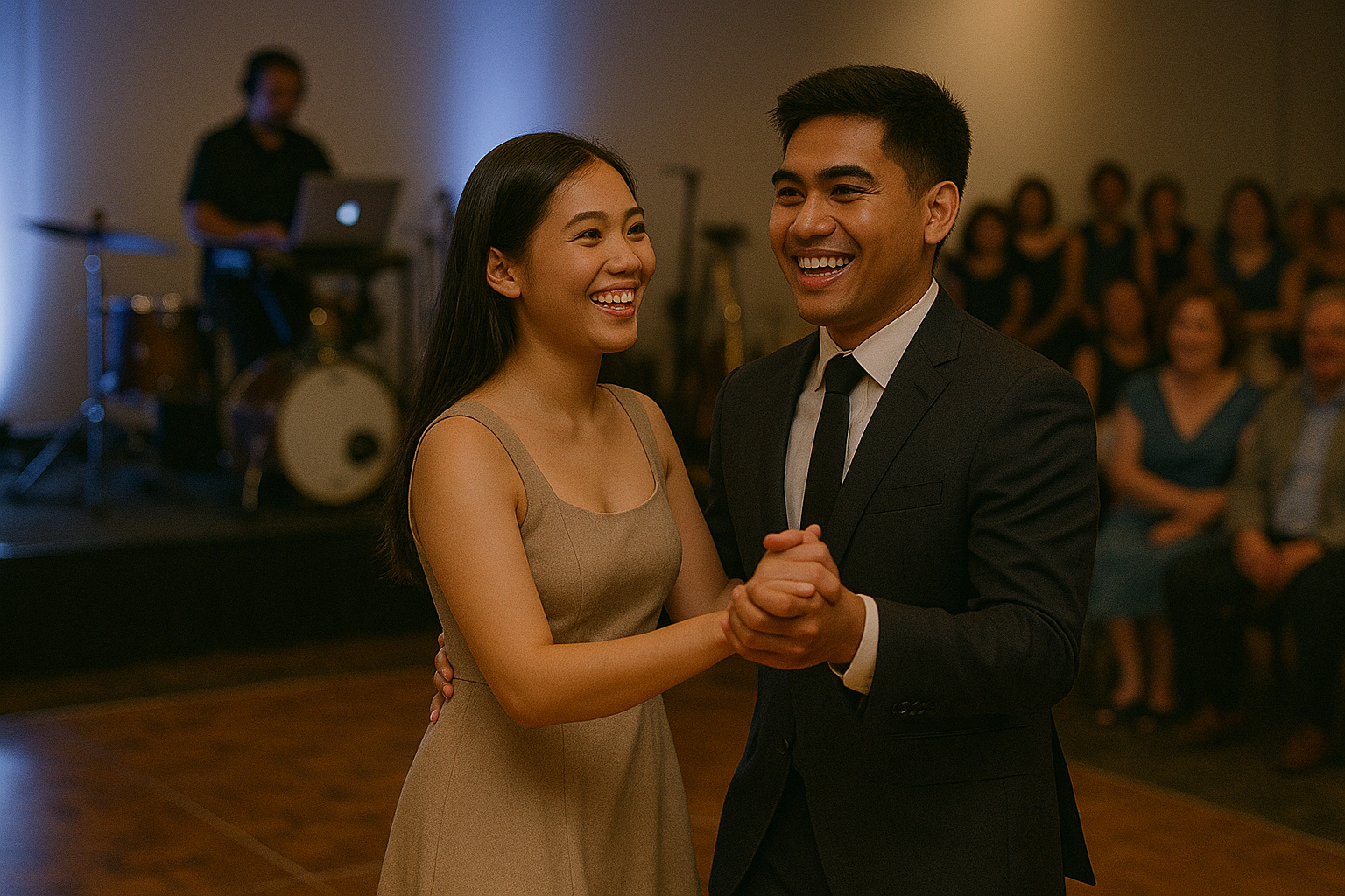 Young Filipino couple dancing while the DJ cues romantic songs and guests look on