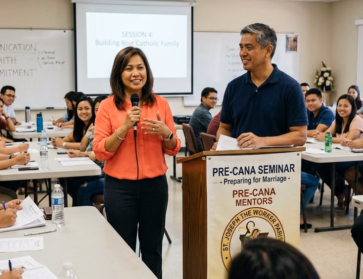 Married Filipino couple serving as Pre-Cana mentors leading a discussion before engaged couples in a Philippine parish seminar room.
