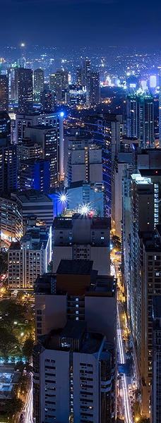 A city skyline at night, with tall buildings lit up