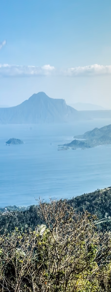 A scenic view of a lake with islands and mountains in the background
